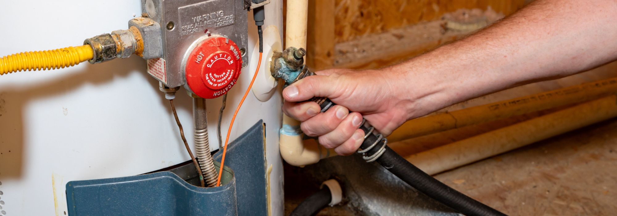 technician fixing a water heater